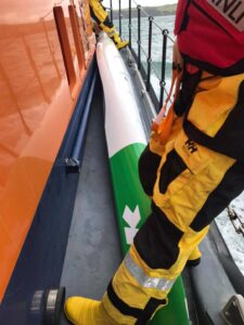 Capsized racer saved after smoke flare is seen