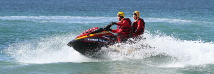 Kayakers in difficulty fire hand flare to summon help